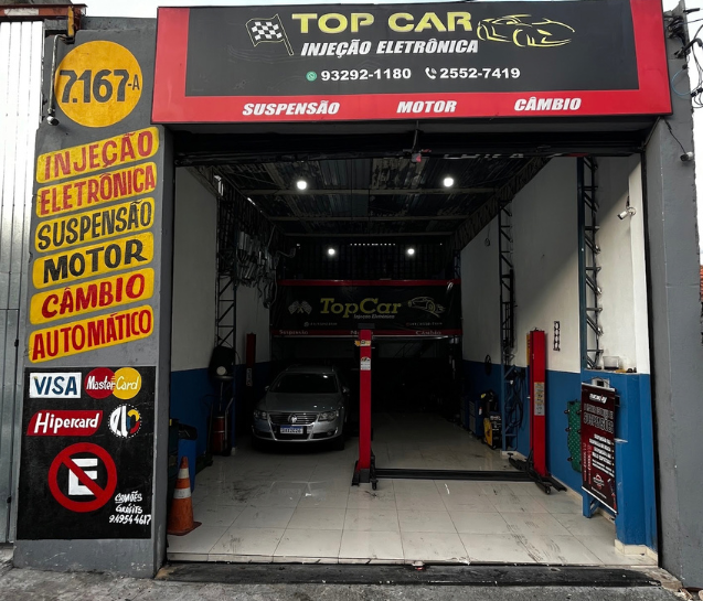 Fachada da Top Car na Av. Nordestina, com o letreiro e o portão aberto